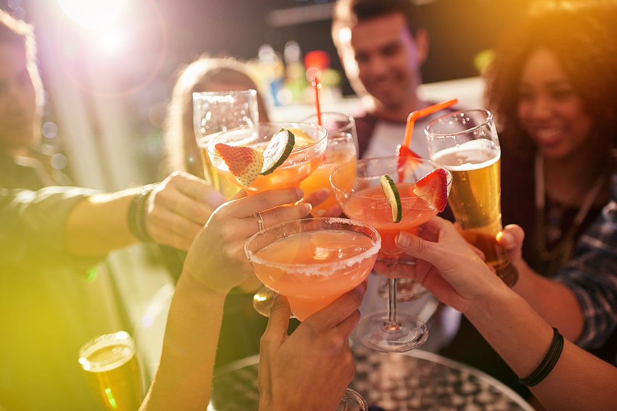 A group of friends toasting with their drinks at Sip Sip